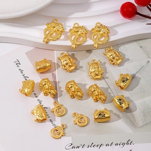 Detailed view of gold charms featuring traditional Chinese dragon and fortune symbols