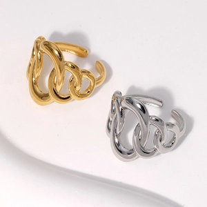Detail of irregular geometric twisted rings in polished gold and silver stainless steel