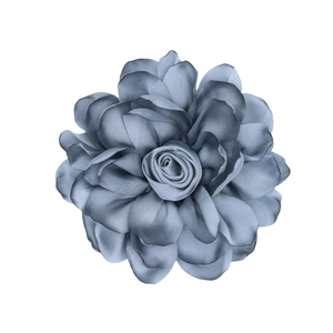 Detail of dusty blue satin fabric rose with refined edges for DIY floral hair accessories