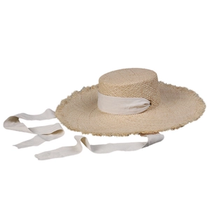 Summer raffia straw boater hat with wide frayed brim and cream-colored ribbon straps