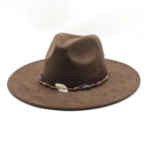 Brown suede jazz fedora hat with ethnic beaded band and shell detail on white background