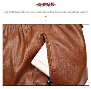 Detail view of anti-theft zipper pocket on brown lychee pattern leather handbag