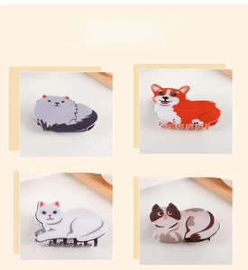 Detail showing various animal-shaped hair claws including cats and corgi dogs in resin