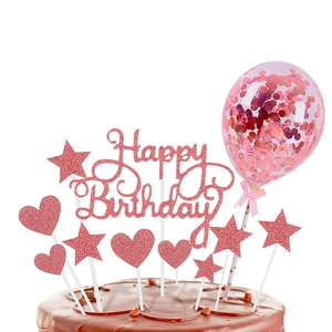 Close-up of pink glitter Happy Birthday cake topper set with sequin balloon decoration