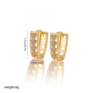 Detail of V-shaped gold earrings with zircons and floral cutouts, 1.7cm height