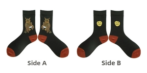 Close-up of black cotton socks featuring owl embroidery and yellow smiley face pattern