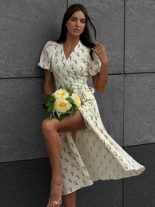 Detail of floral puff sleeve wrap dress with yellow tulip print on off-white fabric