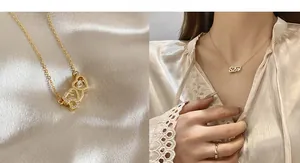 Detail of gold 520 heart pendant necklace and wavy ring set on champagne silk backdrop