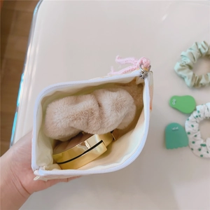 Detail view of mini cotton floral pouch showing inner storage for makeup and accessories