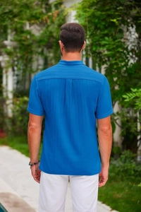 Detail of royal blue linen-textured fabric and pleats on the back of a men's shirt
