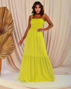 Detailed view of neon yellow maxi dress featuring elastic smocked bodice and layered skirt