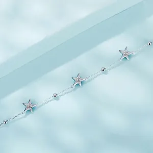 Minimalist S925 sterling silver bracelet with star pendants on light blue background