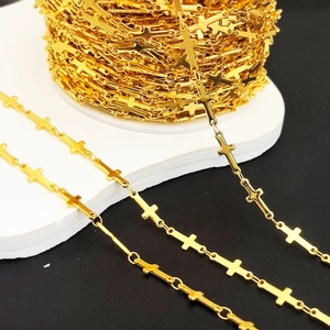 Macro view of gold cross chain for DIY jewelry making displayed on white stand