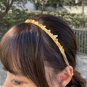 Detailed close-up of handmade gold headband with natural yellow stone chips for women