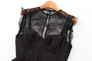 Detail of black lace patchwork top with structured cups and delicate floral textures