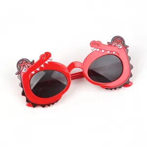 Close-up of cute red crocodile sunglasses for kids with dark grey UV lenses