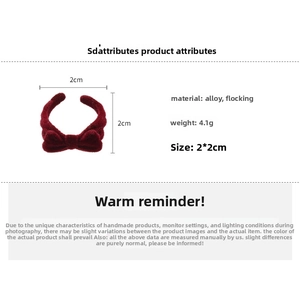 Detail view of red flocked bow ring showing dimensions of 2x2cm and alloy material