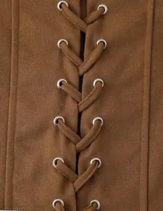 Close-up of brown suede jacket detailing with criss-cross lacing and silver eyelets