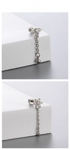 Detailed view of silver titanium steel heart and flower drop earrings with screw backs
