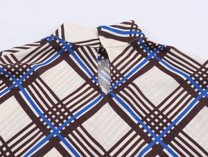 Detail showing the mock neck collar and drop-shaped back cutout of the plaid shirt