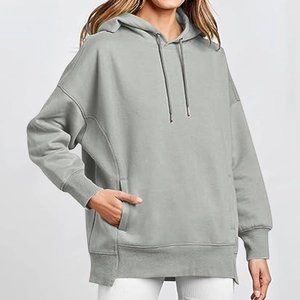 Detail of light grey oversized hoodie with drop shoulders and front kangaroo pocket