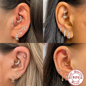 Close-up of S925 sterling silver ear cuffs and hoops with cubic zirconia inlay details