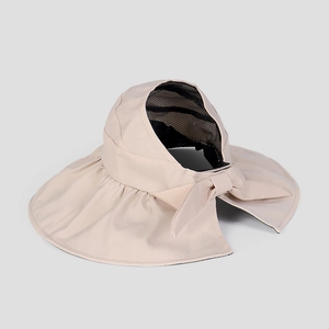 Detail of wide-brim sun visor with large bow and black mesh lining for UV protection