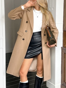 Detail view of camel double-breasted long sleeve trench coat with wool blend texture