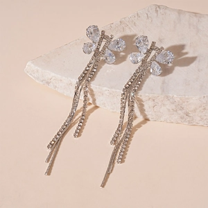 Macro shot of silver butterfly tassel earrings featuring sparkling teardrop zircons