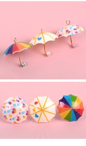 Detail of miniature colorful umbrella pendants for DIY dollhouse crafts and jewelry