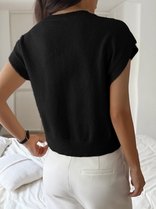 Detail view of the deep V-back design on this black short-sleeve knit sweater