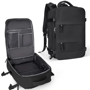 Macro view of black travel backpack showing large internal main compartment and mesh pocket