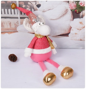Plush Christmas reindeer doll in pink with golden sequins sitting on a holiday display