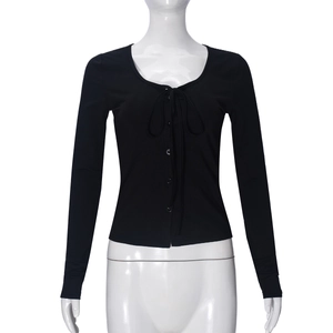 Detail of slim fit long sleeve top with deep U-neck lace-up design and button placket