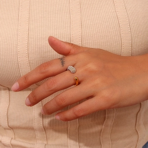 Detail of gold open ring with dual teardrop design and micro-pave texture on model hand