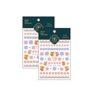 Pixel art fox and snowflake nail stickers with adhesive backing on white background