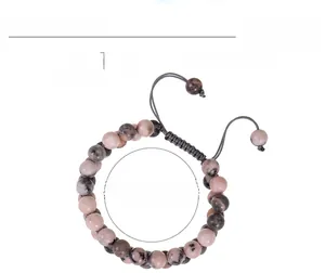 Detail showing 8mm pink zebra stone beads and adjustable woven cord of the bracelet