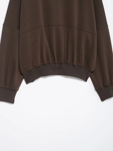 Detailed view of the ribbed cuffs and hem on this dark brown casual sporty sweatshirt