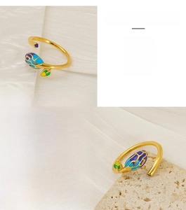 Detailed macro view of colorful enamel leaf patterns on a gold-plated stainless steel ring