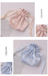 Detail of satin drawstring pouches in dusty pink and silky blue with glossy texture