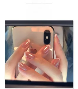 Detail view of almond press-on nails with soft pink blush and white French tips