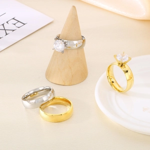 Detailed display of silver and gold stainless steel wedding rings with zircon stones