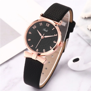 Women's quartz watch with black dial and rose gold case on white marble surface