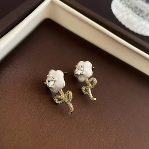 Detail of tulip flower earrings with gold plating, enamel petals and white zircon accents