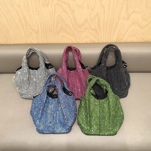 Row of sparkling rhinestone bucket bags in silver, pink, black, blue and green colors