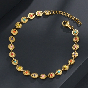 Detail of gold chain bracelet with colorful enamel beads and textured round charms
