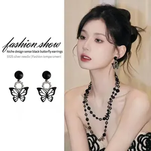 Elegant black butterfly earrings with S925 silver pins shown on model in a collage view