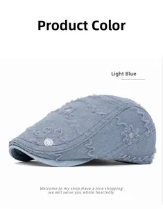 Detail of light blue mesh beret featuring delicate lace trim and sequin floral patterns