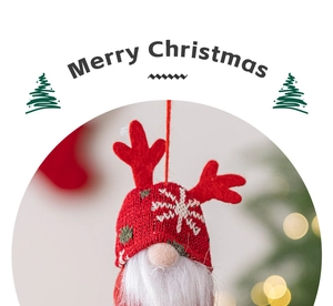 Detail of red gnome ornament with reindeer antlers and Merry Christmas text