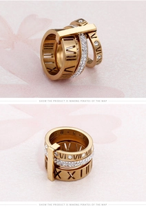 Detailed close-up of gold layered rings with Roman numerals and pavé cubic zirconia